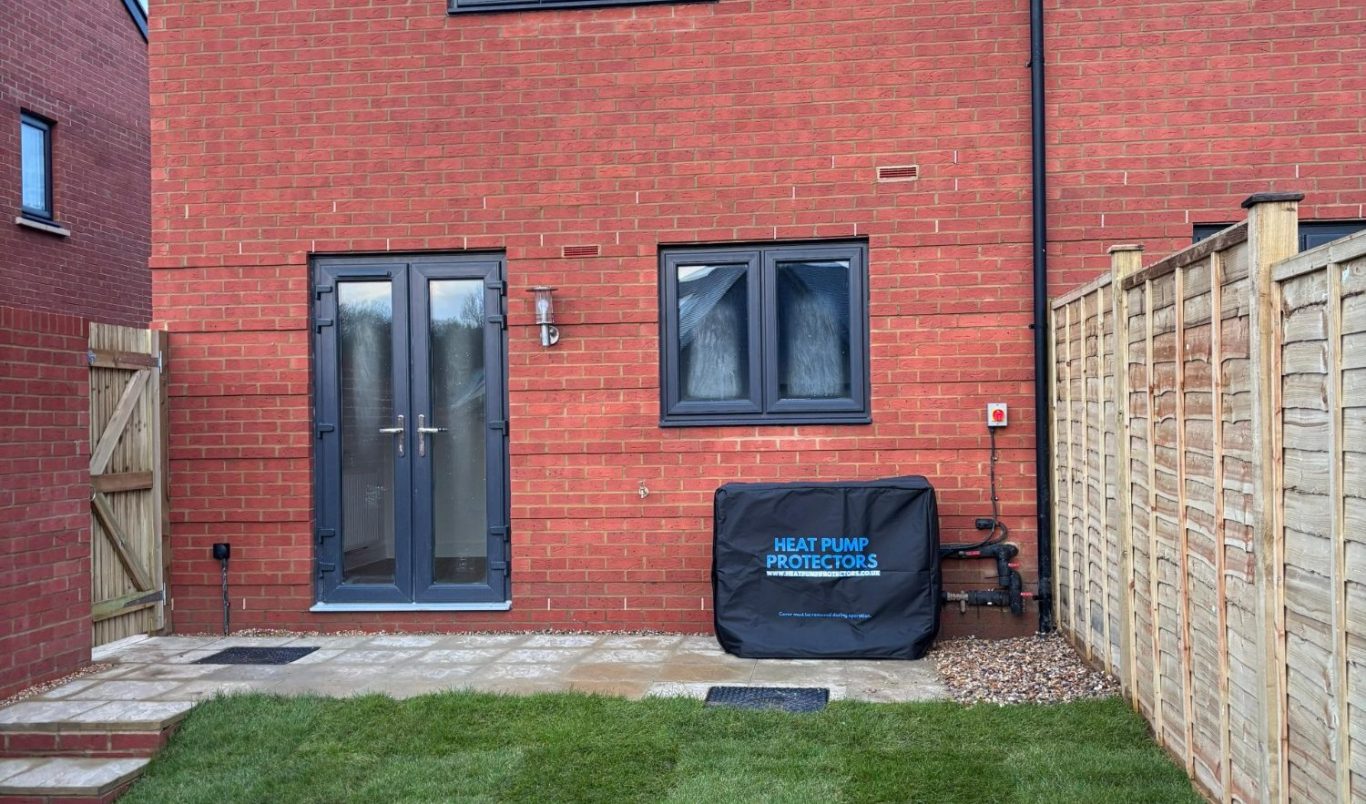 Two construction professionals walking on a site, one in a hard hat and reflective vest.