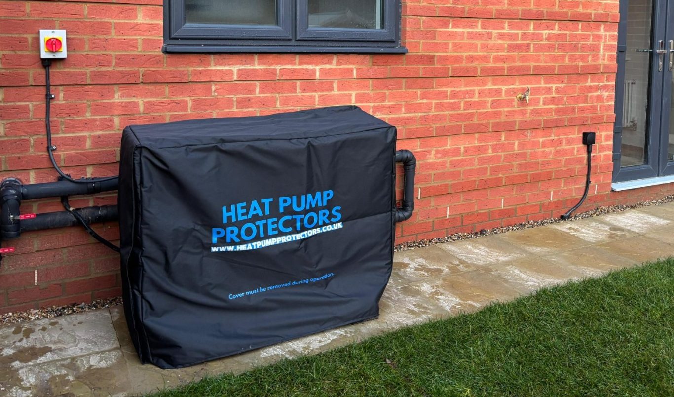 A tape measure with numbers, alongside a blue pencil and fabric on a green cutting mat.